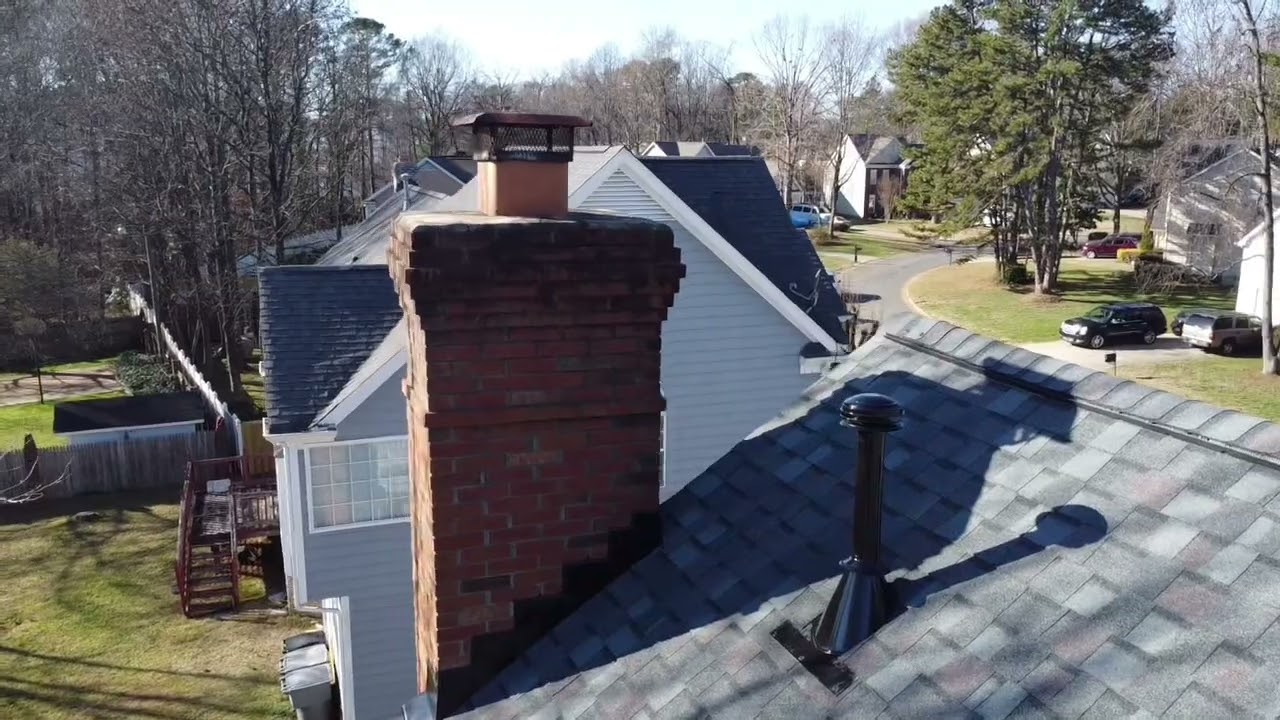 Aerial chimney and shingle detail from a drone flyover